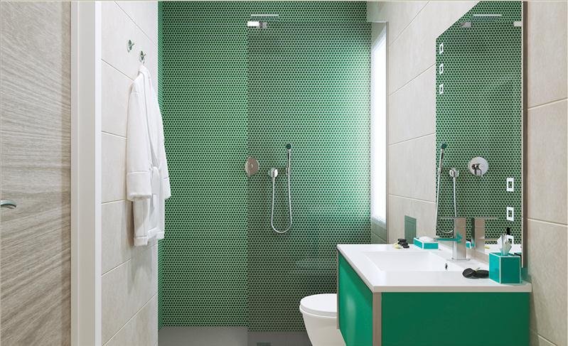 Baño moderno con azulejos verdes