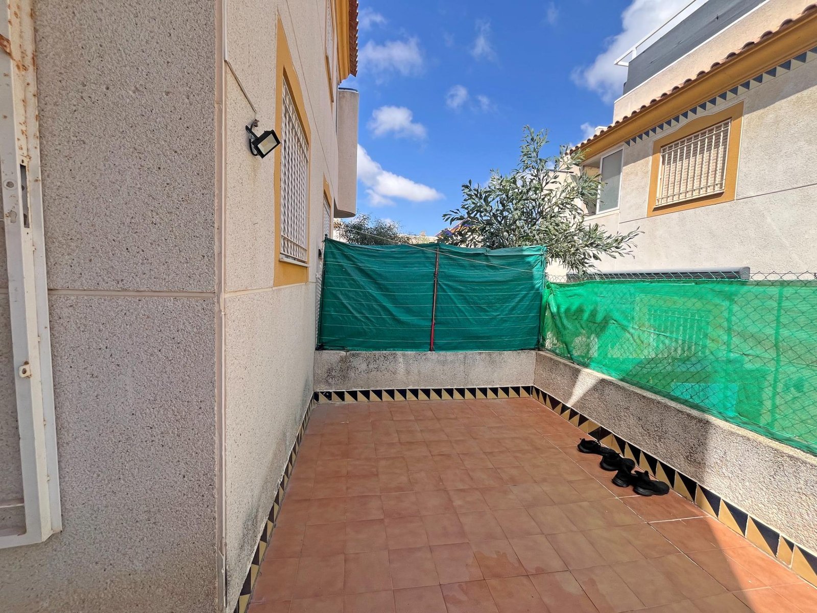 Patio exterior con cerámica y malla