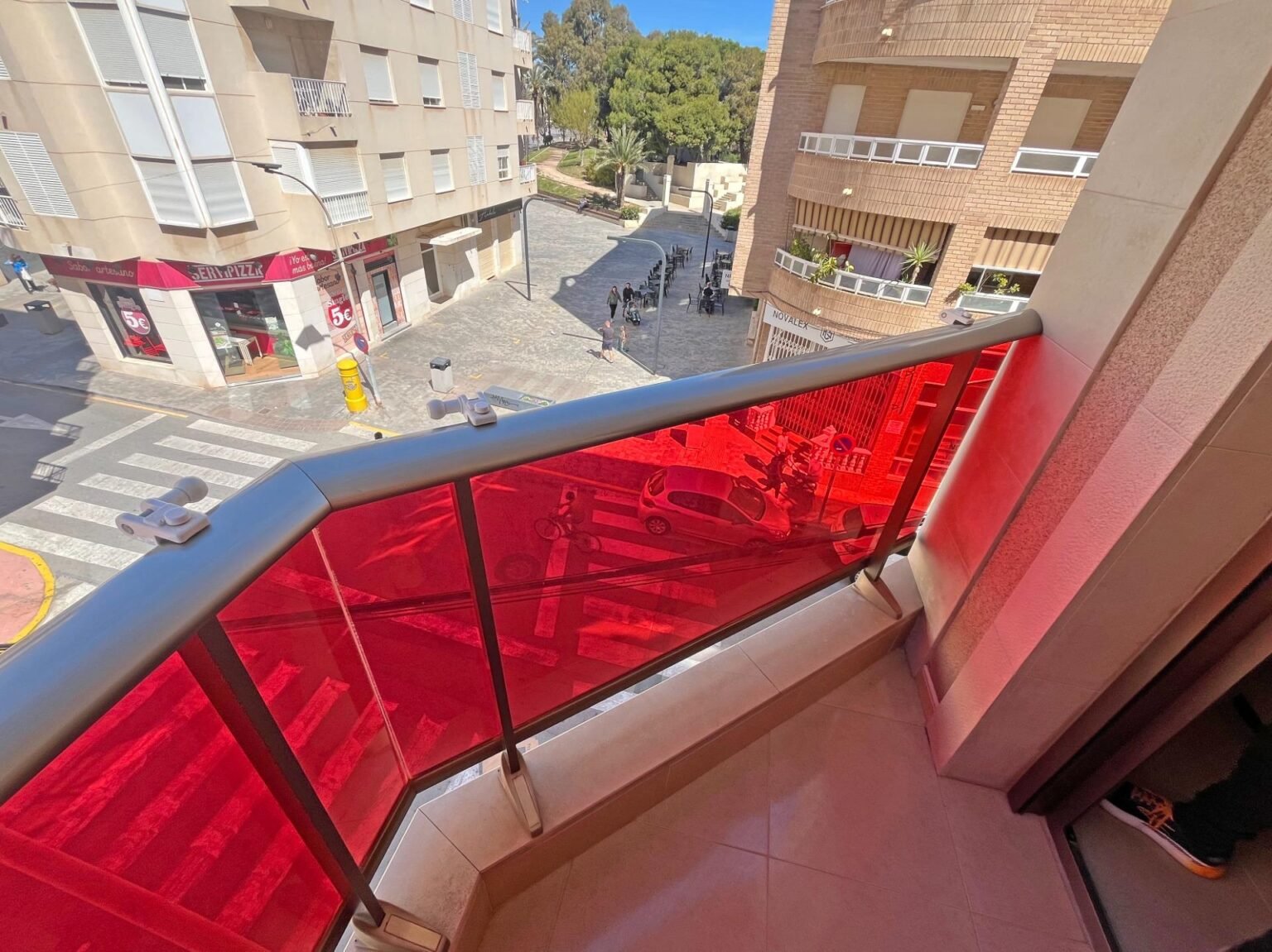 Balcony with red glass railing