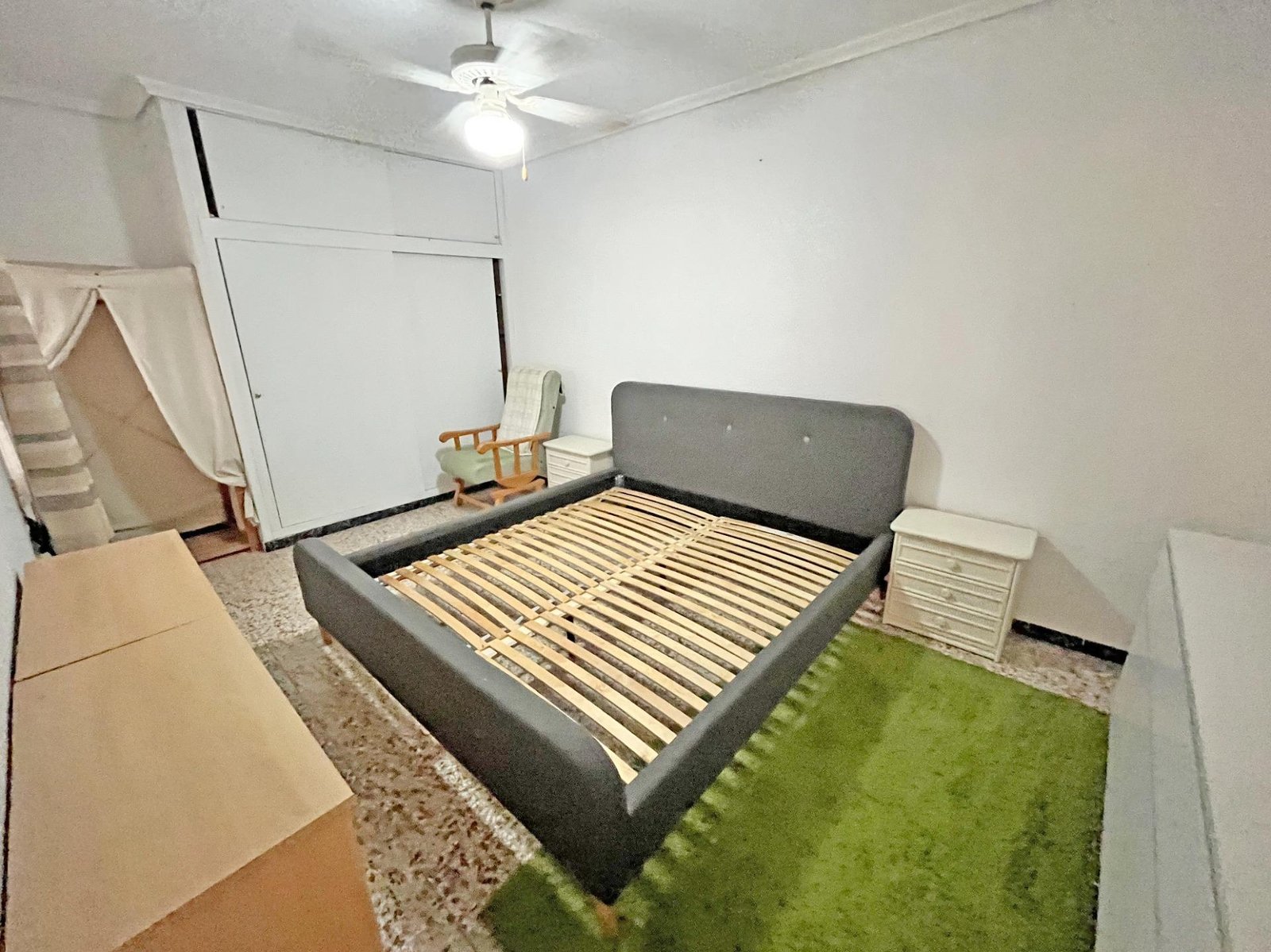 Dormitorio con cama y muebles claros